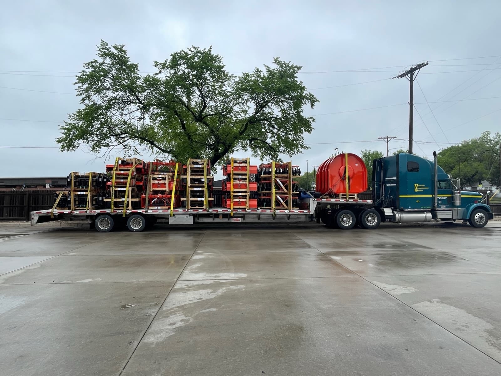 Class 8 flatbed loaded with scissor lifts — real working fleet