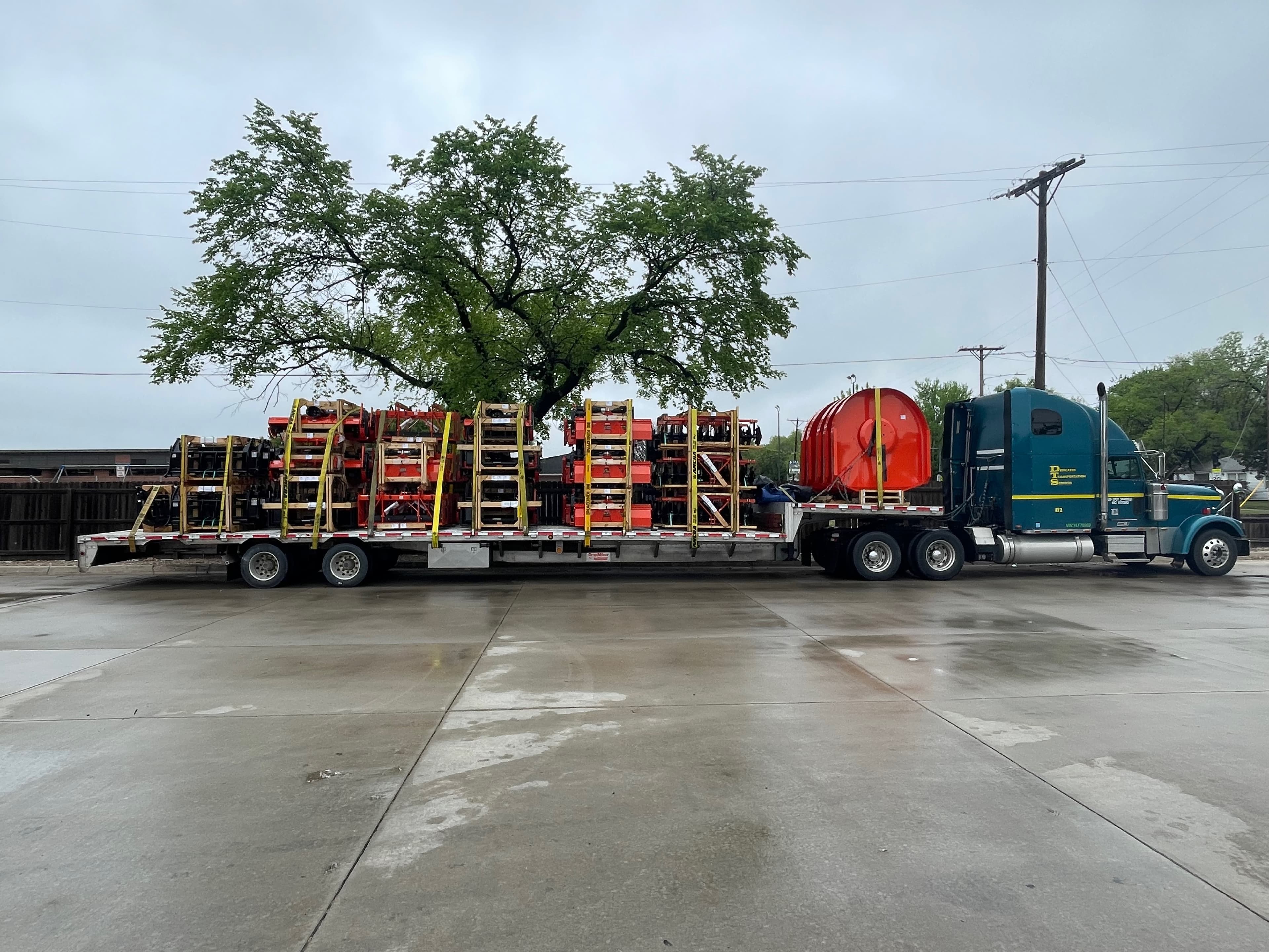Class 8 flatbed loaded with scissor lifts — real working fleet